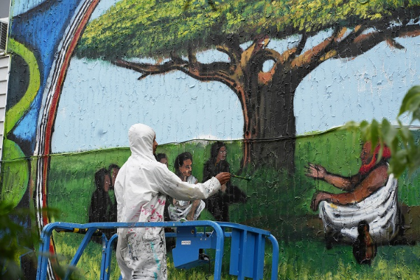 Artist painting a mural