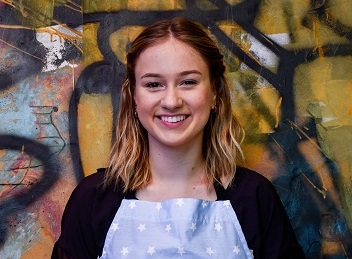 smiling young person in apron