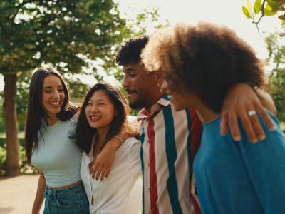 Four people walking and laughing together