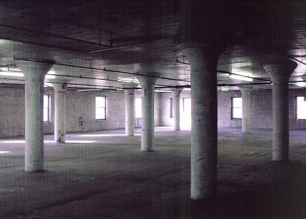 Balck and white interior photo showing reinforced concrete colulmns.