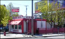 Color exterior photo of red and white one story diner. 2005